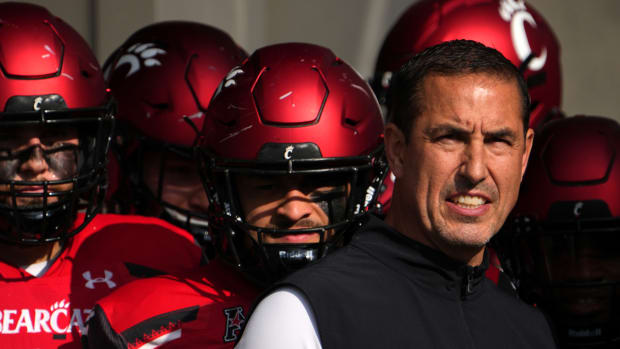 Cincinnati head coach Luke Fickell standing with his team before running onto the field.